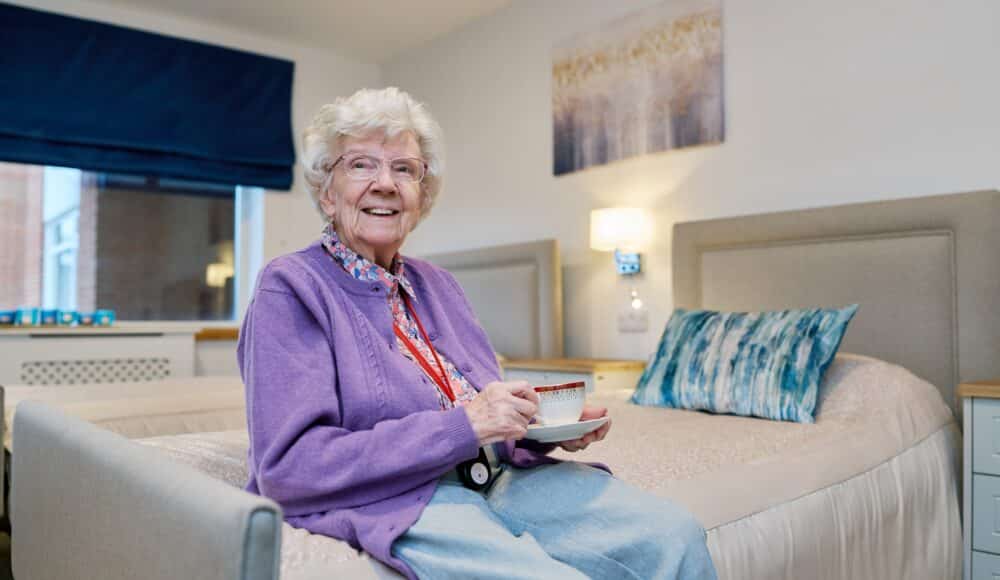 Resident enjoying a hot tea at Devonshire Court care home in Leicester.