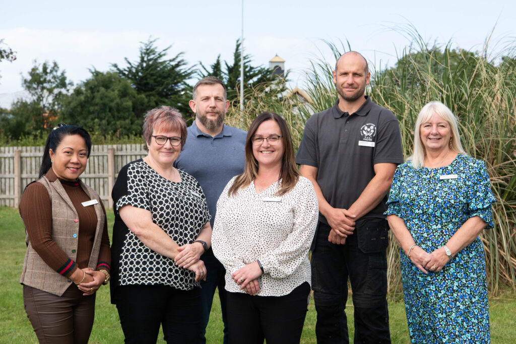 The Home Management Team outside the care home, capturing a moment of togetherness and support.