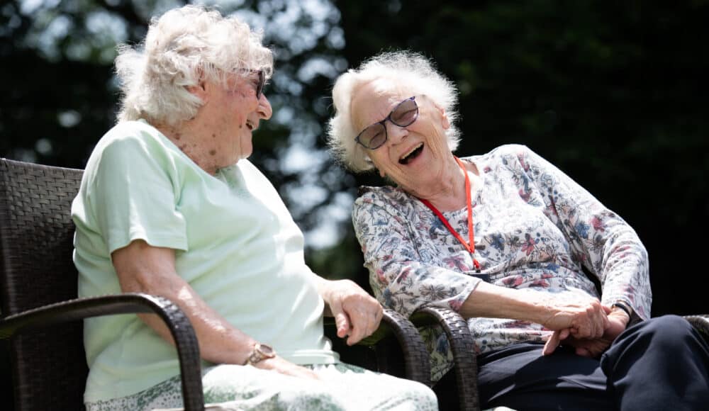 Two female residents laguhing and enjoying the outdoors.
