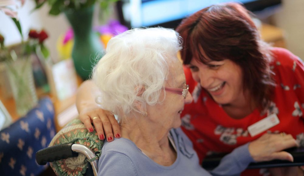 Carer shares a laugh with a Resident