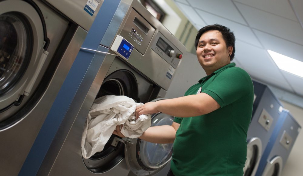Staff member doing laundry at Cadogan Court