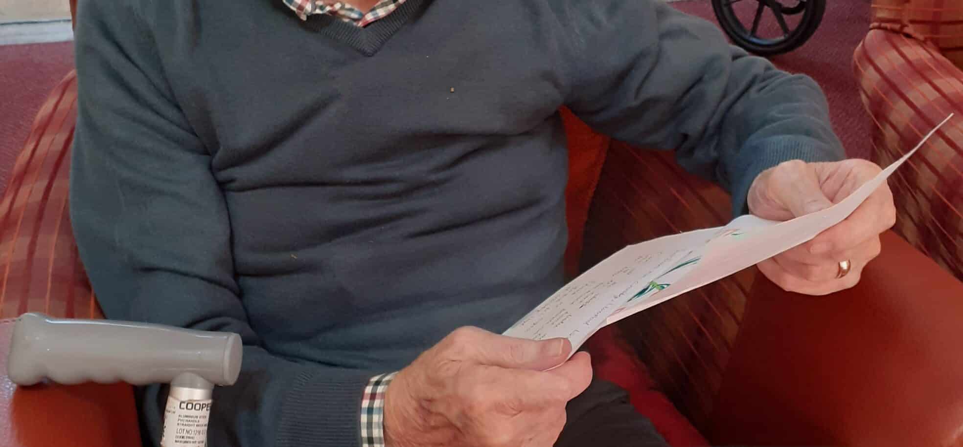 Resident at The Tithebarn reads a message of support from the local community