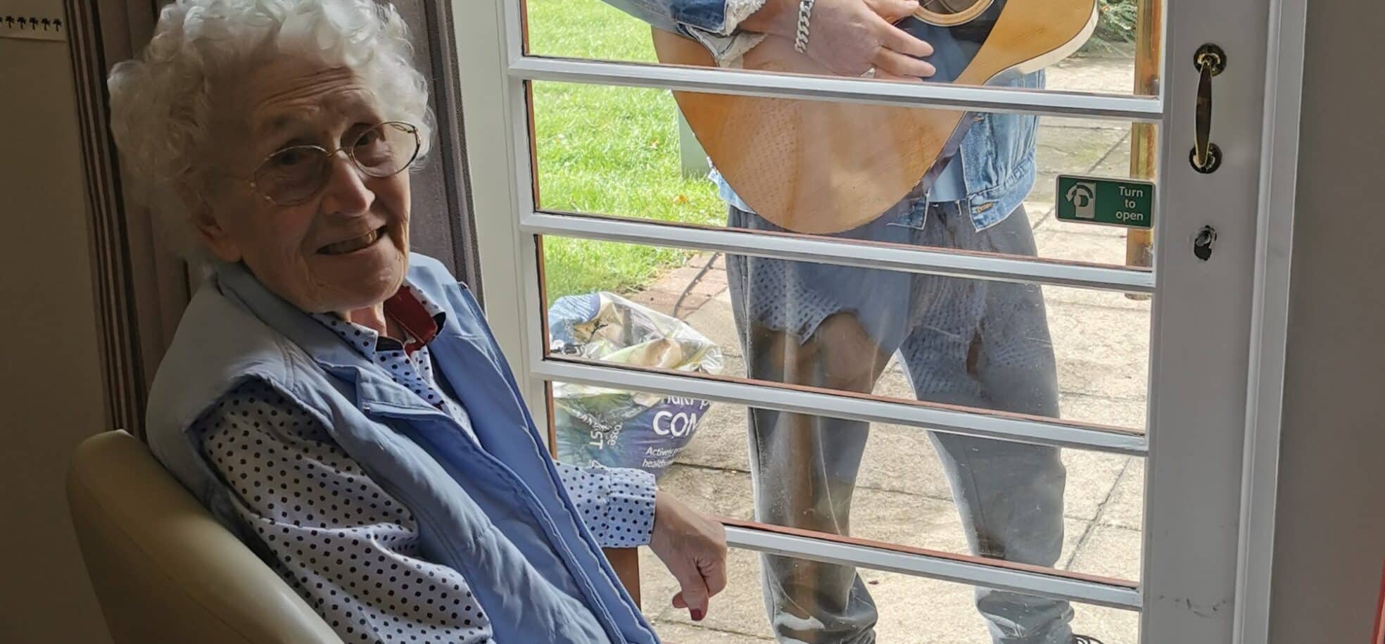 Local musician Pete Brill performs for delighted resident Betty