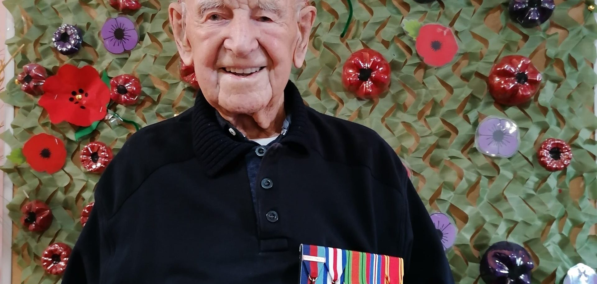 Scarbrough Court resident and WWII veteran Joe Dixon, aged 107, in front of the Home’s Remembrance Day display