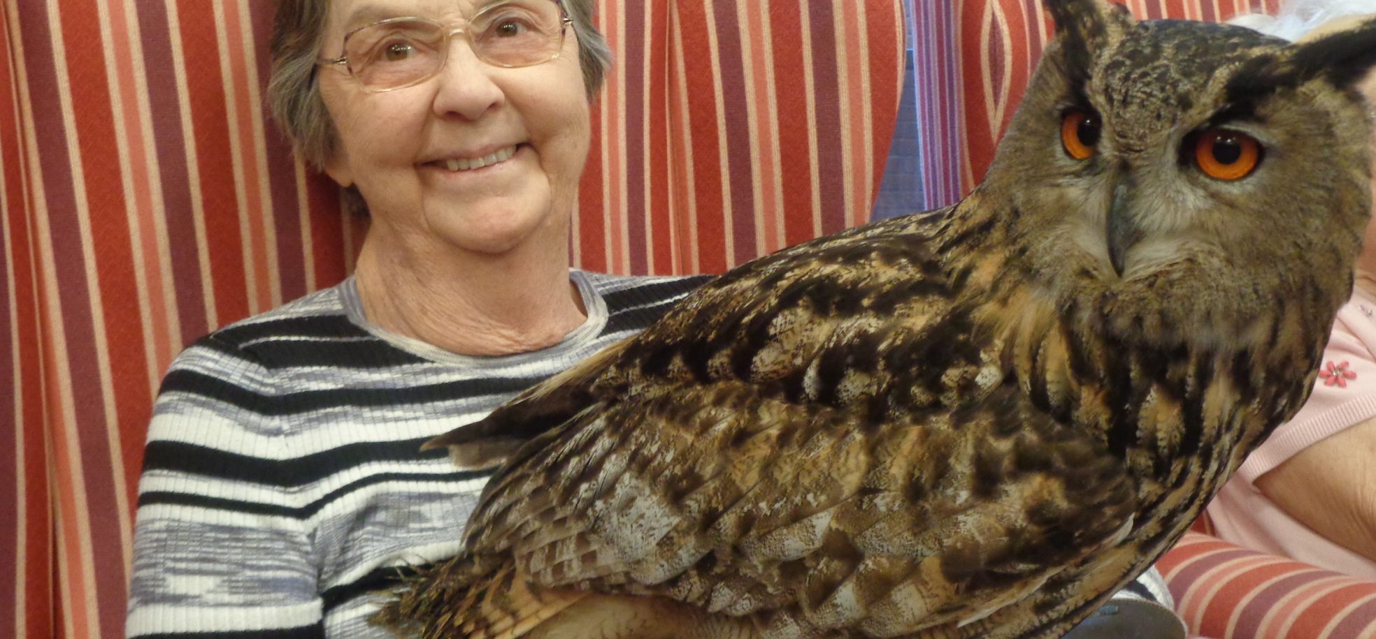 Resident Paula Anderson with Echo the European Eagle owl at RMBI Home Cadogan Court