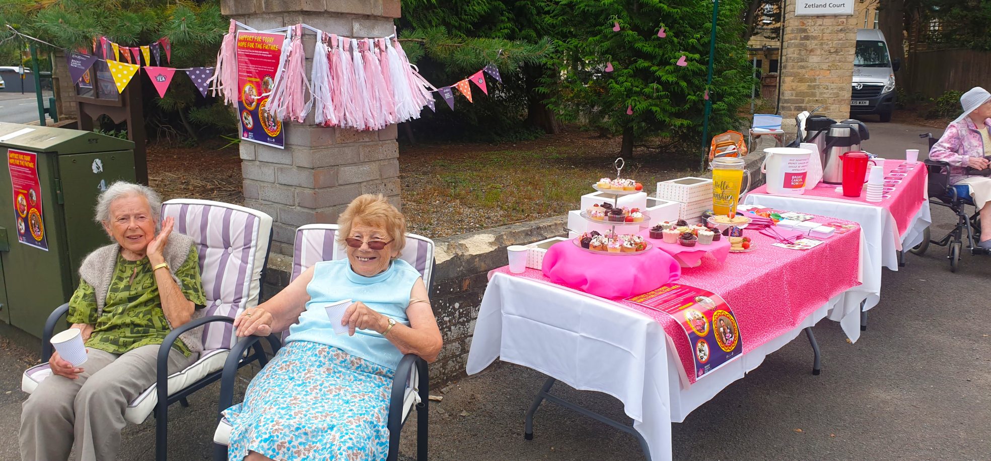 Residents Christine Sorge and Betty Fendley offer tea and cakes to passers-by in exchange of donations for Breast Cancer Now.