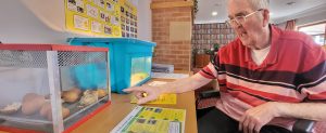 Resident Peter Nevin is delighted to watch a baby chick hatch from its egg at RMBI Care Co. Home Scarbrough Court in Cramlington