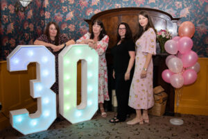 The management team stand proudly with their big ‘30’ sign to mark 30 years since the care home first opened.