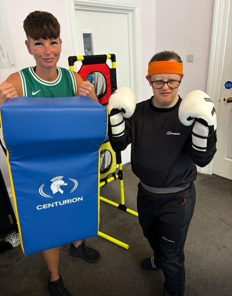 Care home resident Lee tries boxing exercises with staff member Lisa at RMBI Care Co. Home Harry Priestley House, in Doncaster