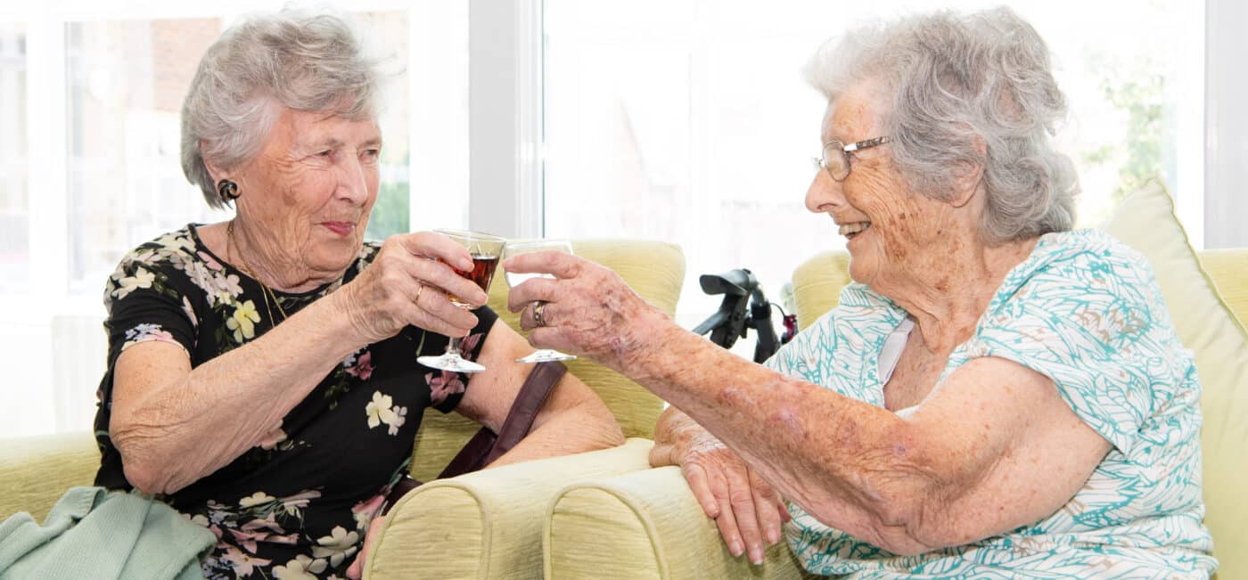 Residents Pat Lyster and Maureen Trotter cheering with drinks at Connaught Court, in York.