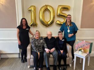 Resident Ron with the care home management team.