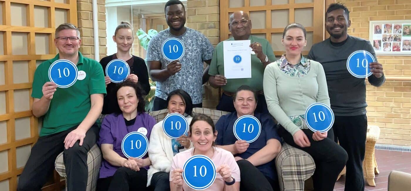 Staff at RMBI Care Co. Home Prince Michael of Kent Court, in Watford celebrate their top score on Carehome.co.uk.