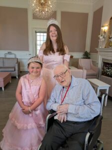 The resident and two young girls, smiling.