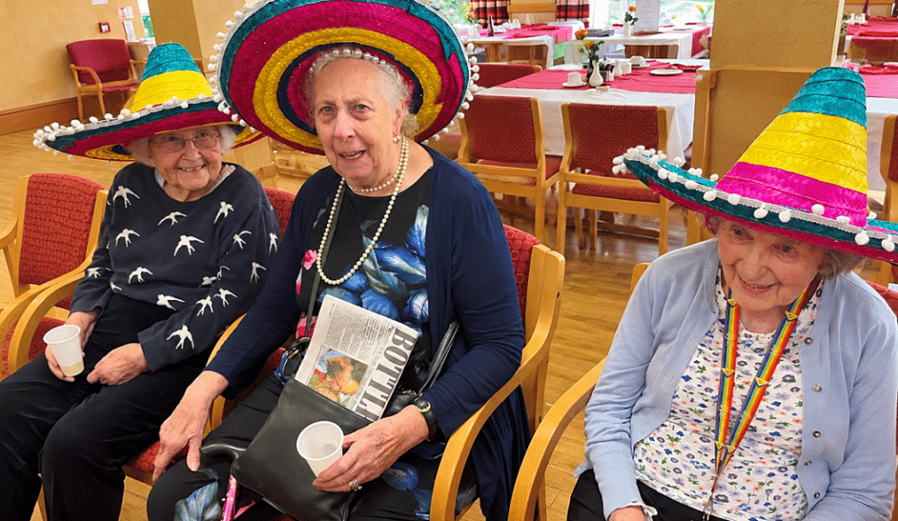 Residents Gill, Brenda and Coral enjoying the “seaside fun” in their festive, summery sombreros